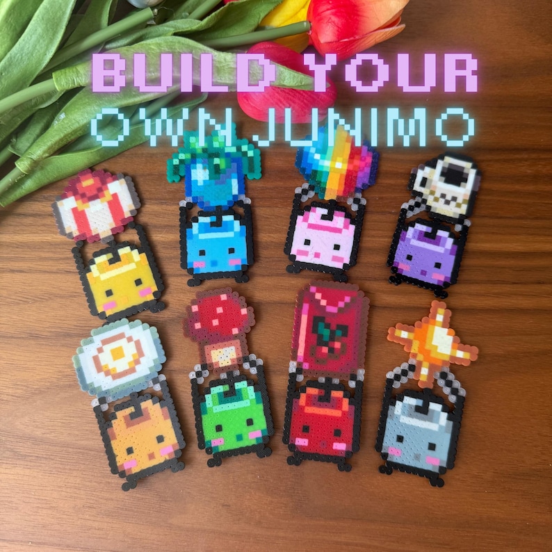 May include: A selection of colourful pixel art Junimo characters, featuring designs in blue, yellow, pink, and purple. Each character has a unique design, some with mushroom or rainbow accents. The text "BUILD YOUR OWN JUNIMO" is displayed above the characters.