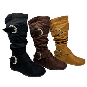 May include: Three pairs of slouchy suede boots with buckle accents. The boots are in black, brown, and tan.