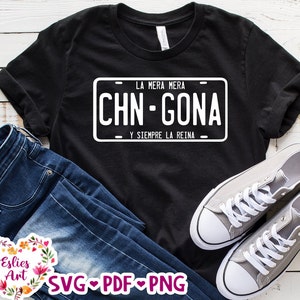 May include: Black t-shirt with a white license plate design that says "LA MERA MERA CHN-GONA Y SIEMPRE LA REINA".