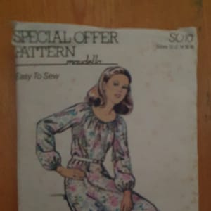 May include: A vintage sewing pattern for a dress with a floral print. The pattern is labeled "Special Offer Pattern" and "Easy to Sew".