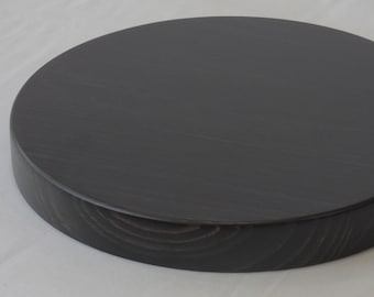 Solid circular wooden bases. Height 3 cm. Black varnish finish. Various measures.