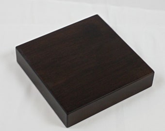 Solid wooden bases. Height 3 cm. Black varnish finish. Various measures.