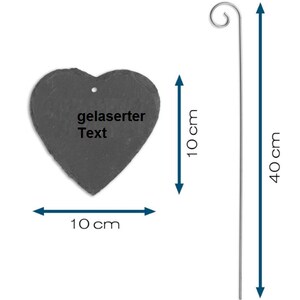 May include: A black heart-shaped slate sign with the text "gelaserter Text" on it. The sign is attached to a 40 cm long metal rod with a hook at the top. The sign is 10 cm wide and 10 cm tall.