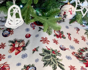 May include: A cream-colored Christmas tree skirt with a red border. The skirt features a repeating pattern of holly leaves, snowflakes, bells, and ornaments.