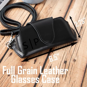 May include: Black full-grain leather glasses case with a strap and silver-tone clasp. The case is 8.5 inches long and 2.75 inches wide. The initials "S|P" are embossed on the front. The text "Full Grain Leather Glasses Case" is displayed below.