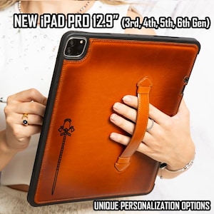 May include: A brown leather case for a 12.9 inch iPad Pro, 3rd, 4th, 5th, or 6th generation. The case has a built-in hand strap and a unique design featuring a stylized axe.