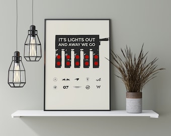 May include: Black and white print with the text "It's lights out and away we go" and a stylized image of a set of traffic lights. Below the lights are logos for various car brands, including Mercedes, Red Bull, McLaren, Ferrari, Audi, Alfa Romeo, Aston Martin, Infiniti, and Volkswagen.