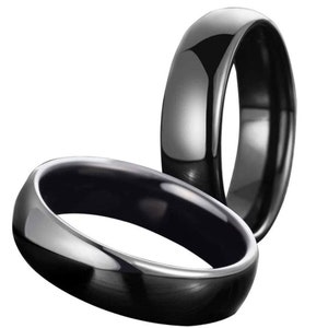 May include: Two black ceramic rings with a high polish finish. The rings are stacked on top of each other.