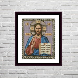 May include: A framed cross-stitch image of Jesus Christ holding a book. The image is set against a purple background with a gold halo around Jesus' head. The text on the book is in Cyrillic.