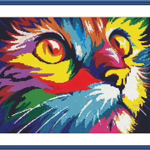 Puede incluir: Una pintura abstracta colorida de la cara de un gato. El ojo del gato es amarillo brillante y el pelaje es una mezcla de rojo, naranja, amarillo, verde, azul, morado y blanco.