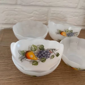 May include: Set of five white ceramic bowls with a scalloped edge. Each bowl features a hand-painted design of a pear and grapes on a vine.