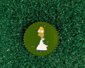 May include: A yellow cartoon character with spiky yellow hair is peeking out from behind a green bush. The character is wearing a white shirt and blue pants. The image is a pin with a green background.