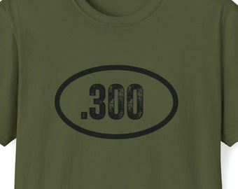 May include: A green t-shirt with a black oval containing the text ".300" in a distressed font.