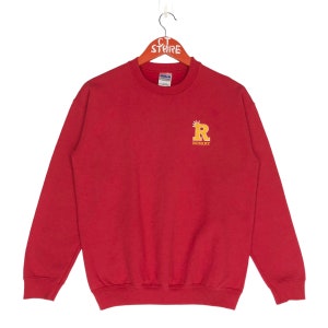 May include: Red sweatshirt with a yellow embroidered letter "R" and the word "ROSARY" below it.