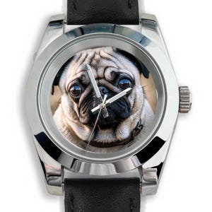 May include: A silver wristwatch with a black leather band. The watch face features a close-up image of a pug dog. The watch has silver hands and a silver bezel.
