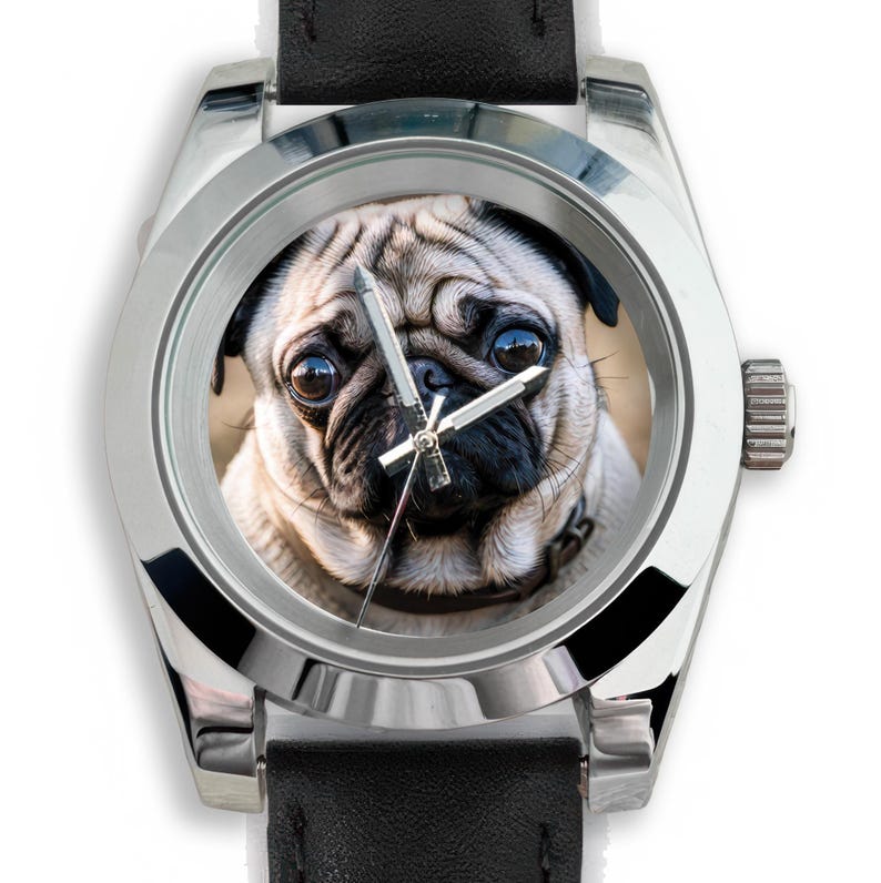 May include: A silver wristwatch with a black leather band. The watch face features a close-up image of a pug dog. The watch has silver hands and a silver bezel.