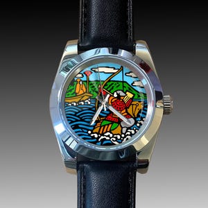 May include: A stainless steel wristwatch with a black leather band. The watch face features a colorful illustration of a person in a boat with a bow and arrow, with a mountain and water scene in the background.