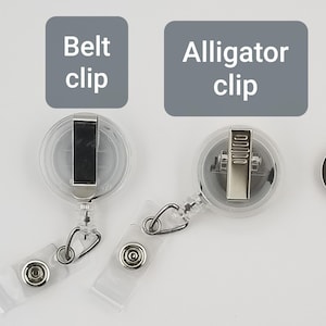 May include: Clear plastic retractable badge holders with metal clips. One has a belt clip, the other an alligator clip. The text on the image reads "Belt clip" and "Alligator clip".