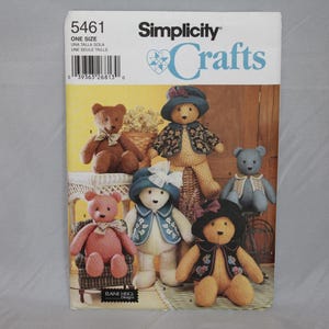 May include: A Simplicity Crafts sewing pattern envelope, number 5461, featuring illustrations of six stuffed teddy bears in various colors and outfits, including hats and vests, with the text Simplicity Crafts and Elaine Heigi Designs visible.