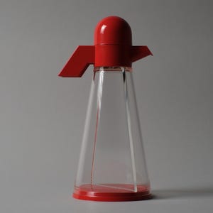 Deadstock Design. This first image features the Bicondi oil and vinegar cruet in its rare, "New Old Stock" condition. Designed by Chiodelli Farinatti for Biesse, this piece is a masterclass in 1980s Italian plastics, combining radical geometry with playful, primary-colored functionality.