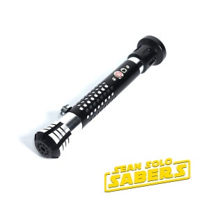 May include: Black lightsaber hilt with a silver band and a textured black grip. The hilt has a red button and a small hole on the side. The hilt is labeled "SEAN SOLO SABERS".