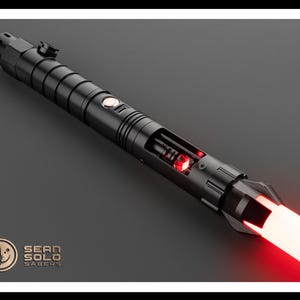May include: A black lightsaber with a red blade. The lightsaber is partially disassembled, revealing the internal components. The lightsaber is labeled "Sean Solo Sabers".