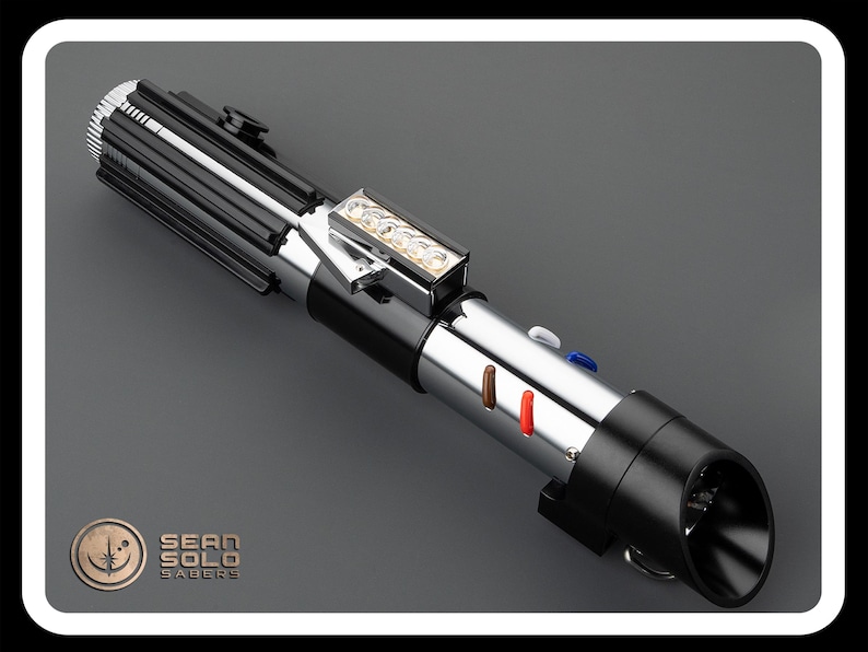 Op de afbeelding: Een zwart en zilveren lightsaber met een zilveren handvat en een zwarte blade. Het handvat heeft een zilveren knop en een zilveren ring. De blade is verlicht met een wit licht. De lightsaber staat op een grijze achtergrond. Sean Solo Sabers.