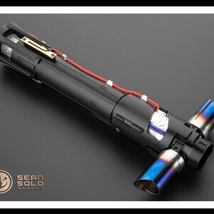 May include: A black lightsaber with a blue and silver tip. The lightsaber is disassembled, showing the internal components. The lightsaber is labeled "Sean Solo Sabers".