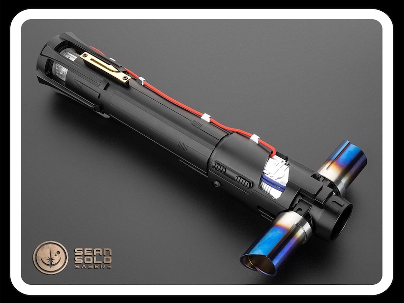 May include: A black lightsaber with a blue and silver tip. The lightsaber is disassembled, showing the internal components. The lightsaber is labeled "Sean Solo Sabers".