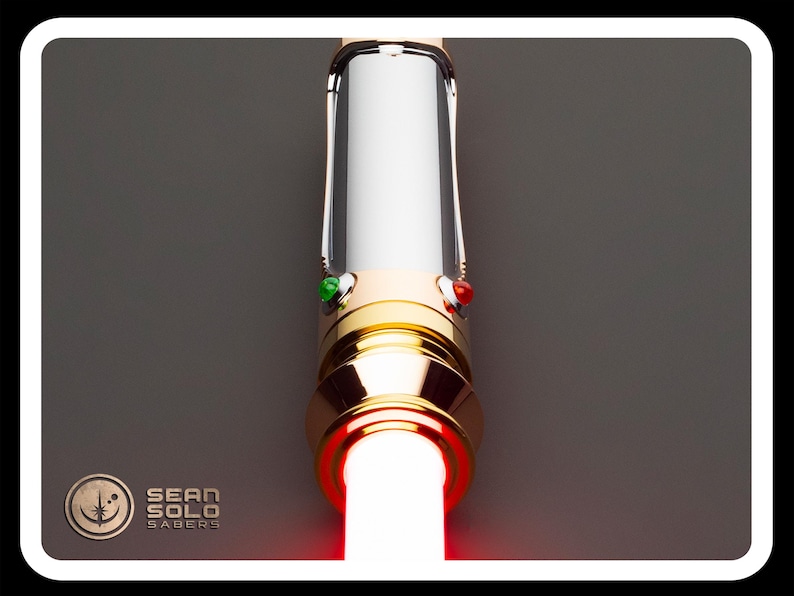 May include: A lightsaber with a gold and silver hilt, featuring a bright red blade. The hilt has green and red buttons. The Sean Solo Sabers logo is in the lower left corner.