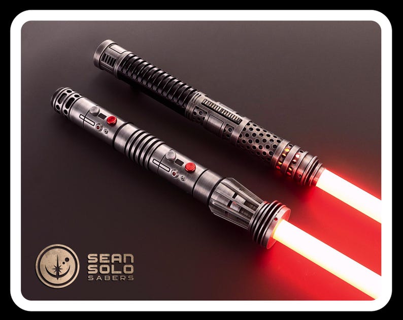 May include: Two metallic lightsaber hilts with glowing red blades. The hilts feature intricate silver and black detailing, circular vents, and red activation buttons. A logo in the corner reads Sean Solo Sabers with a circular star emblem.