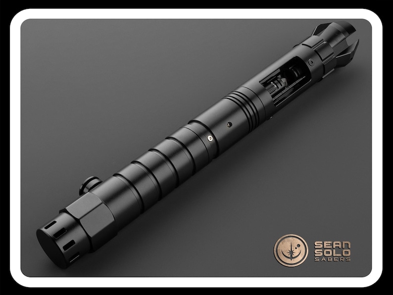 May include: A black lightsaber hilt with a detailed design and a removable blade. The hilt has a textured surface and a silver accent. The hilt is made of metal and has a sleek, modern design.