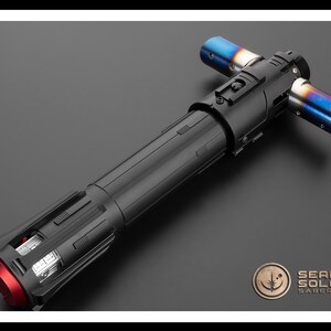 May include: A black lightsaber with a red emitter and blue and silver accents. The lightsaber is made of metal and has a textured surface. The lightsaber is a popular prop for fans of the Star Wars franchise.