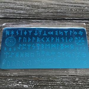 May include: A blue gradient nail art stamping plate featuring various Norse runes and symbols. The plate includes a compass rose, a sun symbol, and the text "MouTeen-044".
