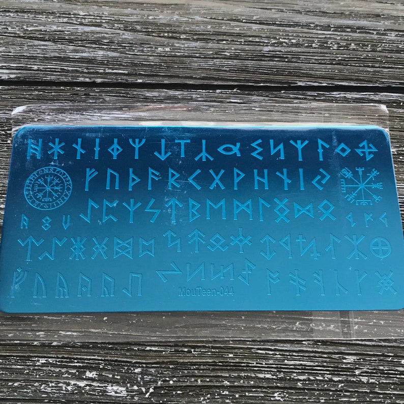 May include: A blue gradient nail art stamping plate featuring various Norse runes and symbols. The plate includes a compass rose, a sun symbol, and the text "MouTeen-044".