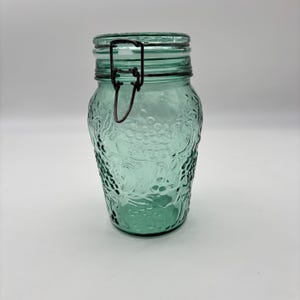 Vintage 90s Teal Glass Canister. Clamp Style Lid. Embossed Fruit Design. 8” Tall