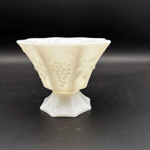 May include: A set of three ceramic mugs with a speckled, matte finish. Each mug features a different color: light blue, cream, and gray. The mugs have a simple, modern design and a comfortable handle.