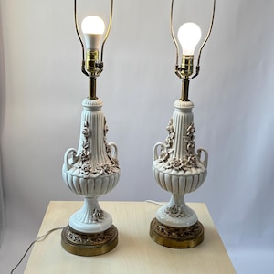 Vintage Pair of Porcelain Table Lamp With 3D Rose Flowers and Ornate Brass Base. Set of 2 Trophy Handle. 33.5”to finial. 22.5” to socket