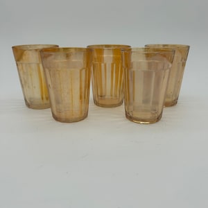 May include: Set of five amber glass drinking glasses with a ribbed design.