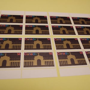May include: A sheet of 14 Canadian postage stamps featuring a black silhouette of a building with an archway. The stamps are arranged in four rows of three stamps each. Each stamp has the word "Canada" and the number "14" printed on it.