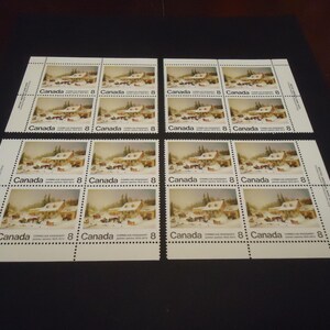 May include: A block of eight postage stamps from Canada, each featuring a winter scene with a horse-drawn carriage and a house. Each stamp is marked with the number 8 and the text Canada. The stamps are arranged in two rows of four.