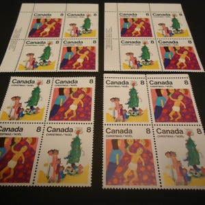 16 sellos navideños canadienses sin usar de 1975: 8 centavos, niños, familias y Navidad.