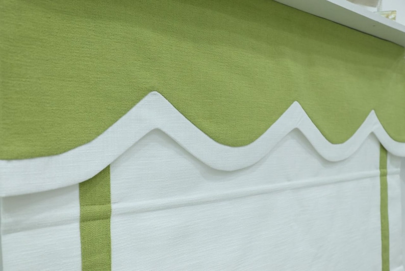 May include: A green and white window valance with a scalloped edge. The valance is made of a soft, textured fabric.