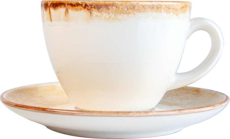 May include: A white ceramic coffee cup with a brown rim and a matching saucer. The cup is empty and the saucer is on a black background.