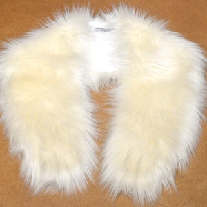 May include: A white faux fur collar. The collar is soft and fluffy, and it would be a great addition to any winter outfit.