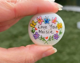 Handmade personalised sparkly keepsake pebble decorated with flowers and a butterfly