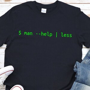May include: A black t-shirt with green text that reads "$ man --help | less".