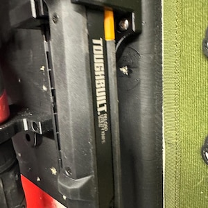 May include: A black and yellow ToughBuilt 16-Gauge Brad Nailer with a black plastic handle and a metal clip.