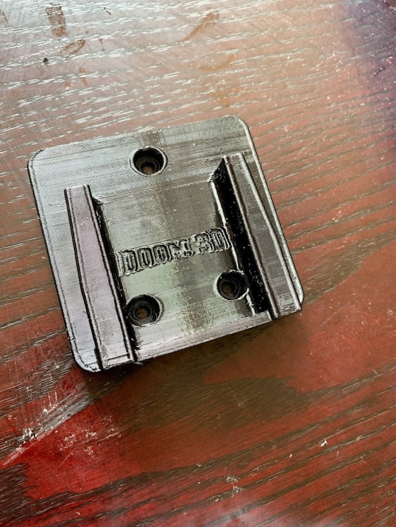 Pu&ograve; includere: Supporto da parete in plastica nera con la scritta "DOOM 3D" stampata su di esso.