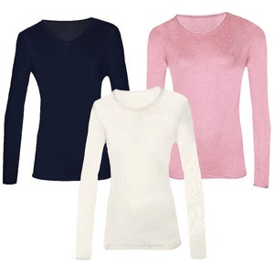 May include: Three long-sleeved shirts in different colours: navy blue, white, and pink. All shirts have a crew neck.